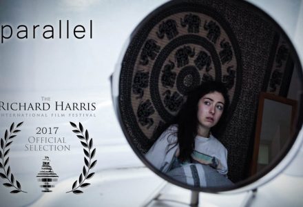Poster for Parallel - a woman's reflection in a round mirror